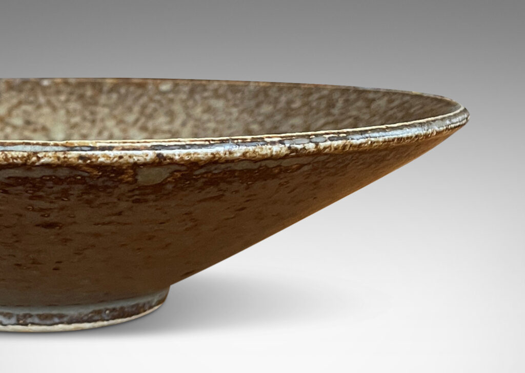 Gallery BAC shallow conical form with thick pale gray over brown glazing; stoneware