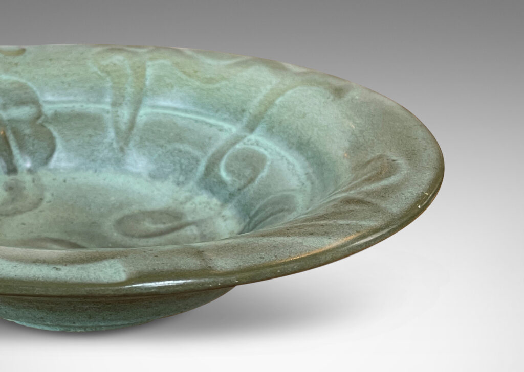 Gallery BAC concentrically lobed form with relief ornaments in gray-green glaze; earthenware