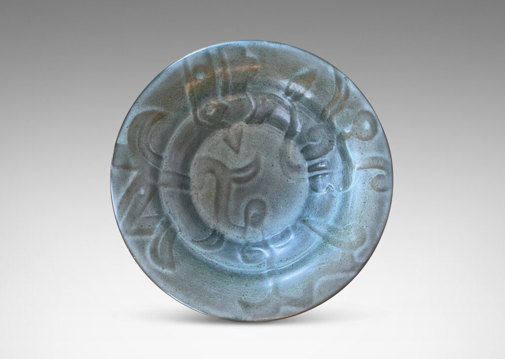 Gallery BAC concentrically lobed form with relief ornaments in gray-green glaze; earthenware