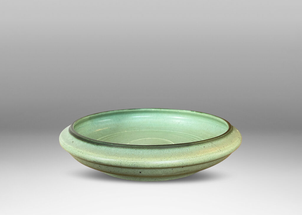 Gallery BAC modeled curved sides and carved concentric circle pattern, glazed in a soft turquoise tone with speckling and outline to rim