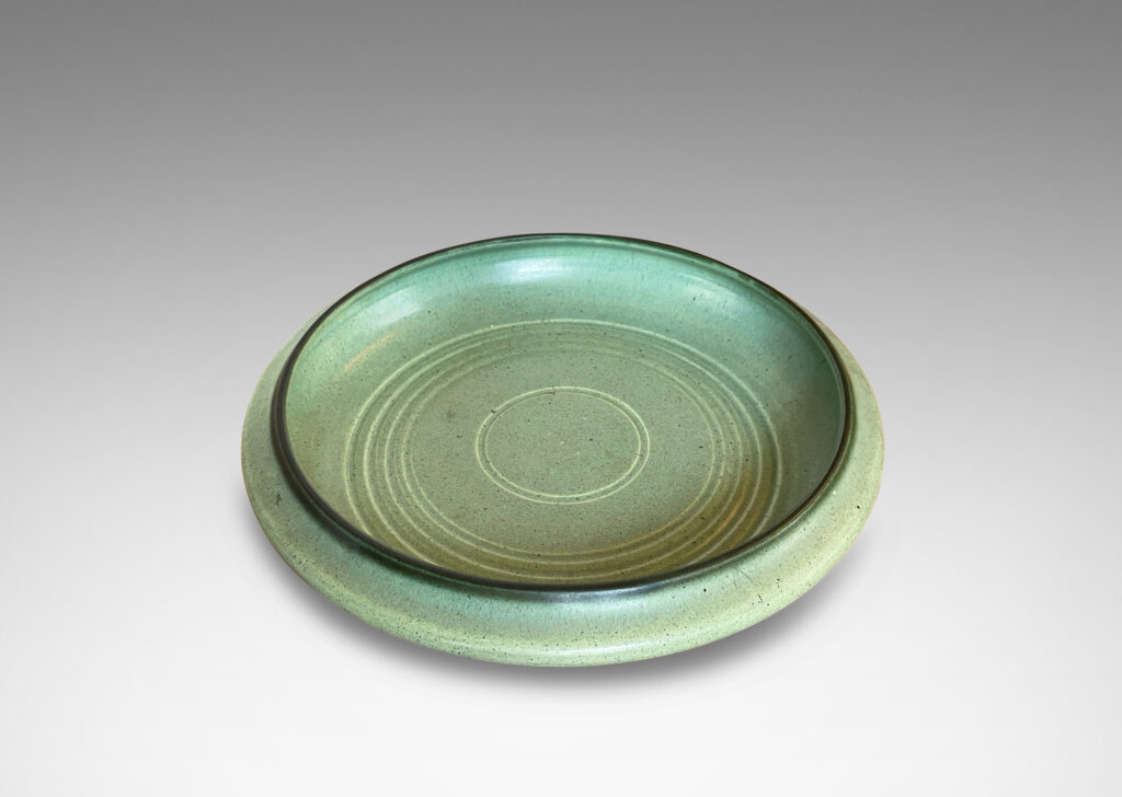 Gallery BAC modeled curved sides and carved concentric circle pattern, glazed in a soft turquoise tone with speckling and outline to rim