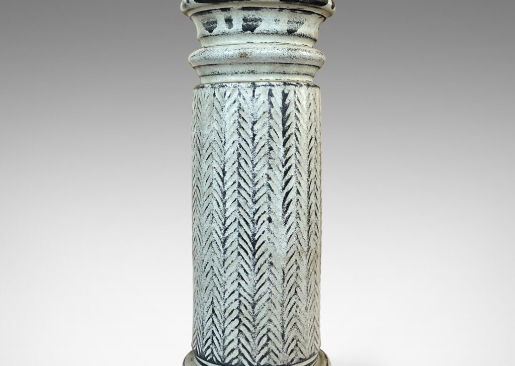 Gallery BAC column forms with sculpted capitals and bases and vertical stripes of carved herringbone