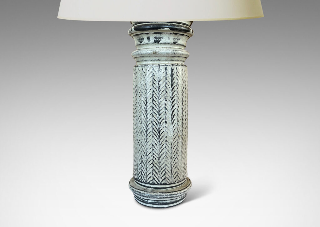 Gallery BAC column forms with sculpted capitals and bases and vertical stripes of carved herringbone