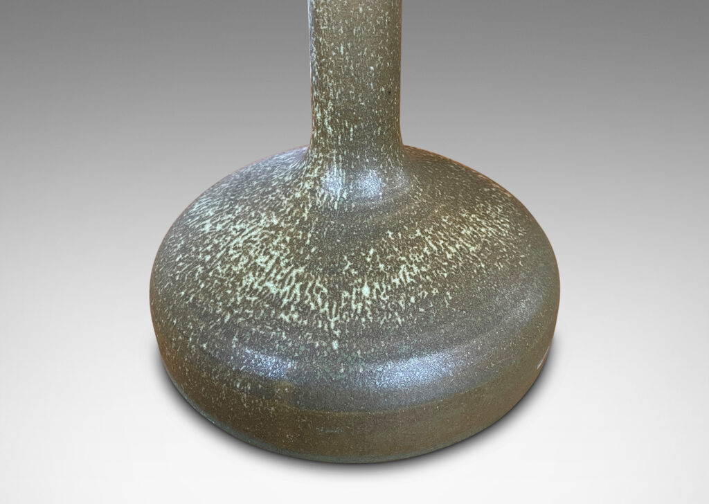 Gallery BAC decanter-like form with low wide drum form and tall neck, glazed in olive green with light green dappling