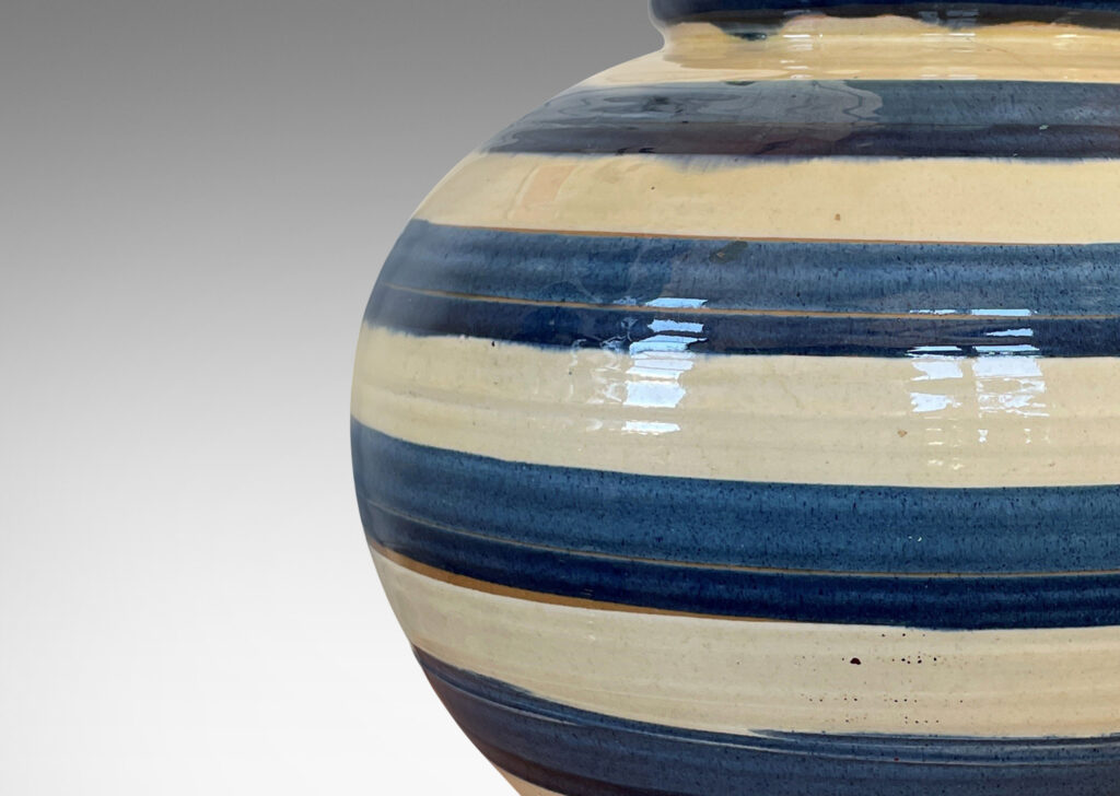 Gallery BAC wide tapering globe form, with beaded lip and plinth base, glazed with horizontal two-tone blue and ivory bands