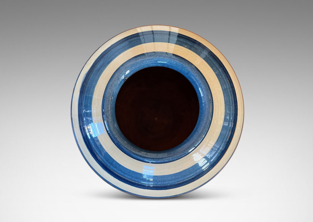 Gallery BAC wide tapering globe form, with beaded lip and plinth base, glazed with horizontal two-tone blue and ivory bands