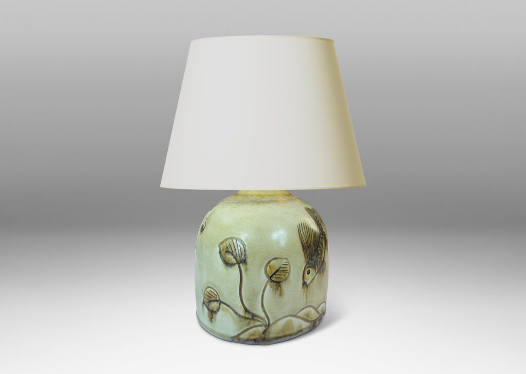 Gallery BAC gumdrop half-round form, carved with charming fish reliefs, glazed in a pale yellow with touches of brown