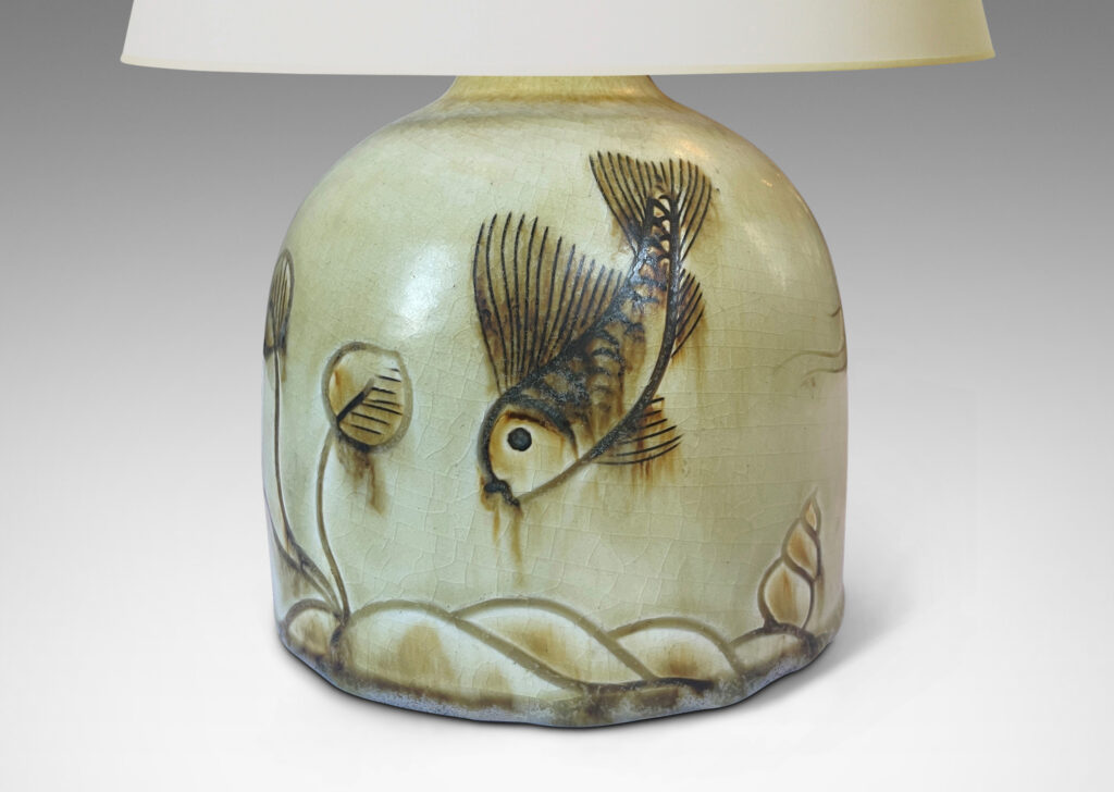 Gallery BAC gumdrop half-round form, carved with charming fish reliefs, glazed in a pale yellow with touches of brown