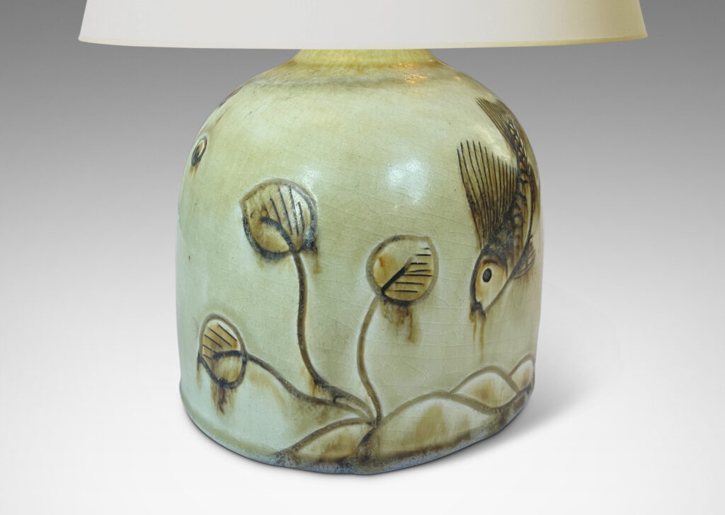 Gallery BAC gumdrop half-round form, carved with charming fish reliefs, glazed in a pale yellow with touches of brown