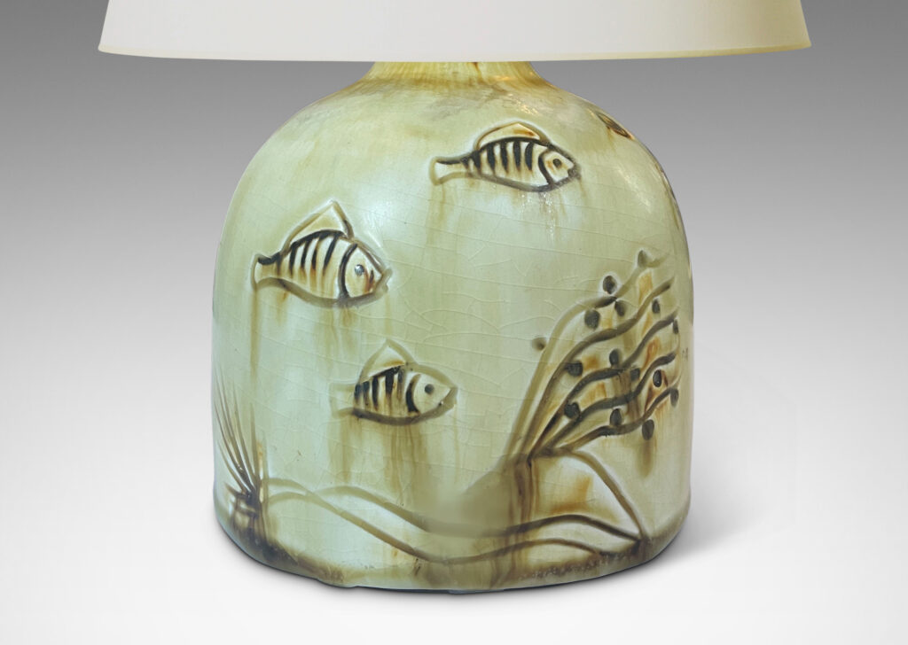 Gallery BAC gumdrop half-round form, carved with charming fish reliefs, glazed in a pale yellow with touches of brown