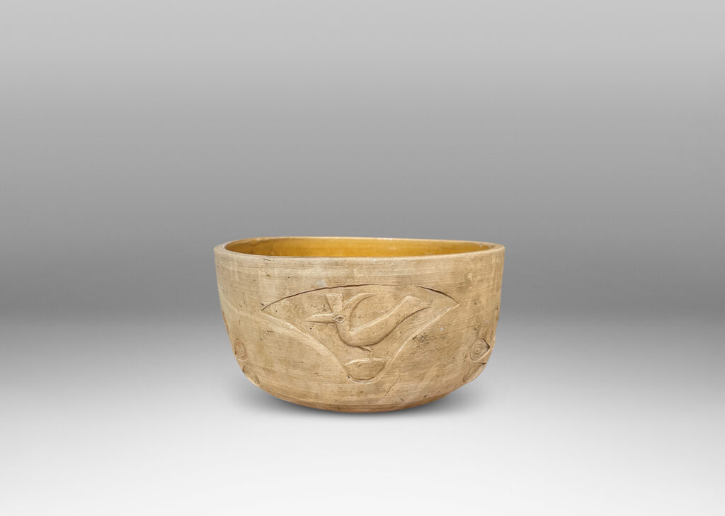 Gallery BAC straight sides decorated with carved animal motifs and stylized flora, and a gloss golden interior glaze