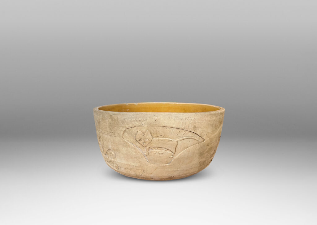 Gallery BAC straight sides decorated with carved animal motifs and stylized flora, and a gloss golden interior glaze