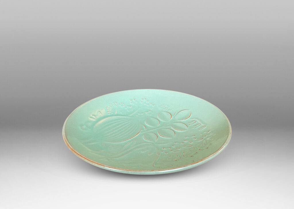 Gallery BAC smoothly modeled concave form with relief floral design inside, glazed in a muted celadon green