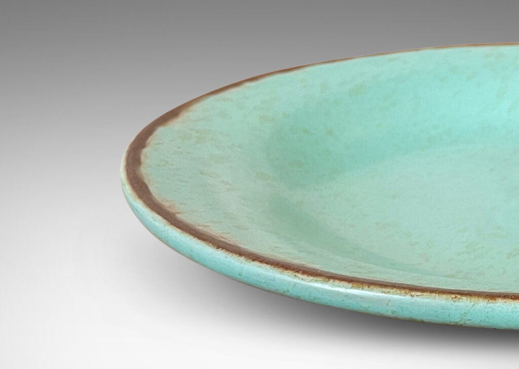 Gallery BAC shallow round form in turquoise glaze with brown rim and dappling