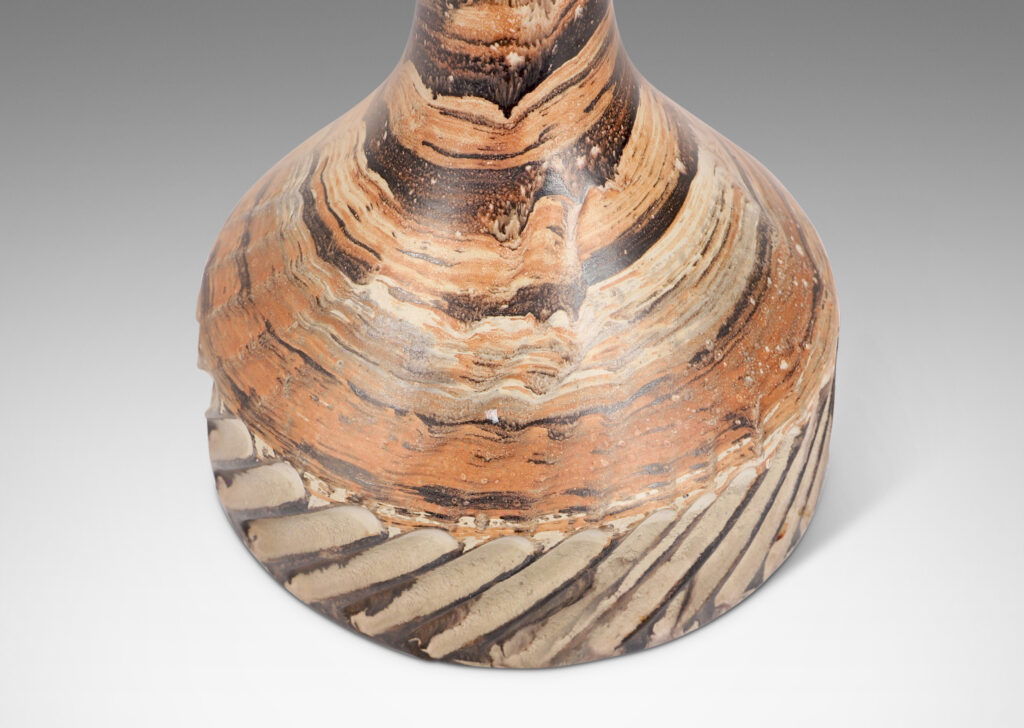 Gallery BAC large pawn-like form, with low drum and tall sprouting neck, glazed in marbled dark brown