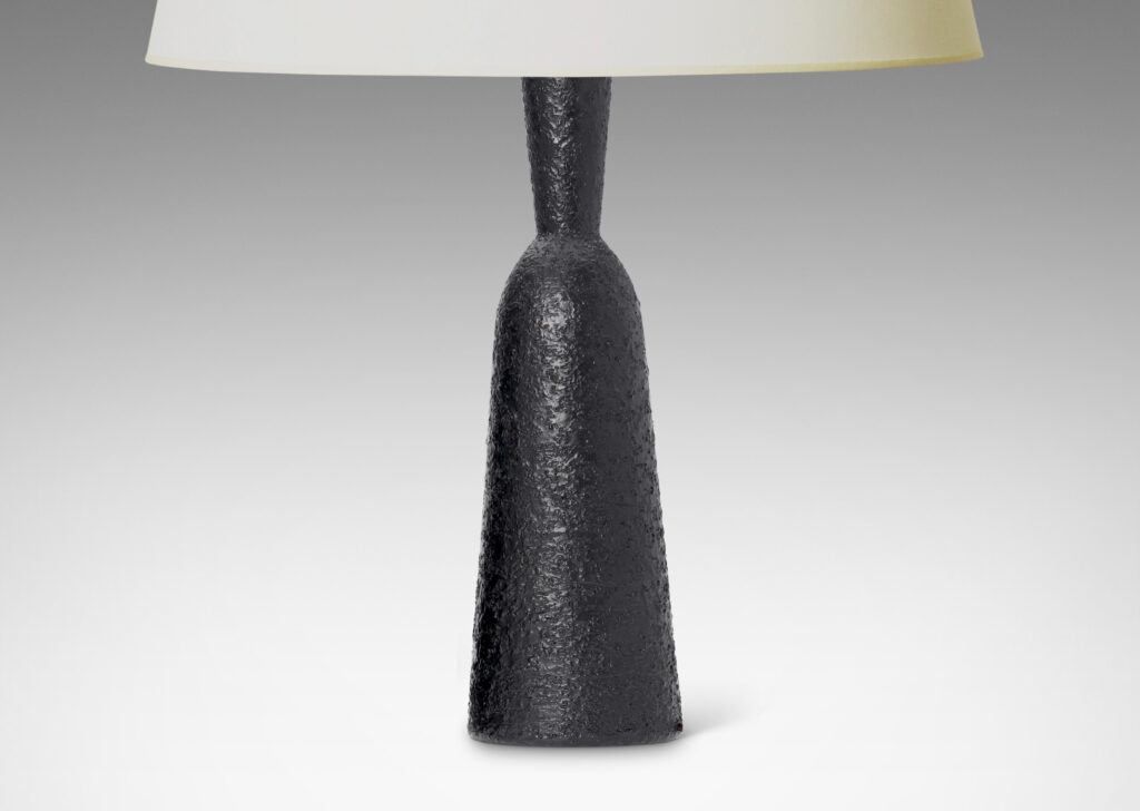 Gallery BAC all and tapered bottle-like forms, with a textured dark gray-black finish evoking the skin of an avocado