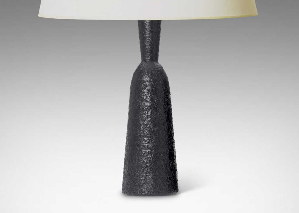 Gallery BAC all and tapered bottle-like forms, with a textured dark gray-black finish evoking the skin of an avocado