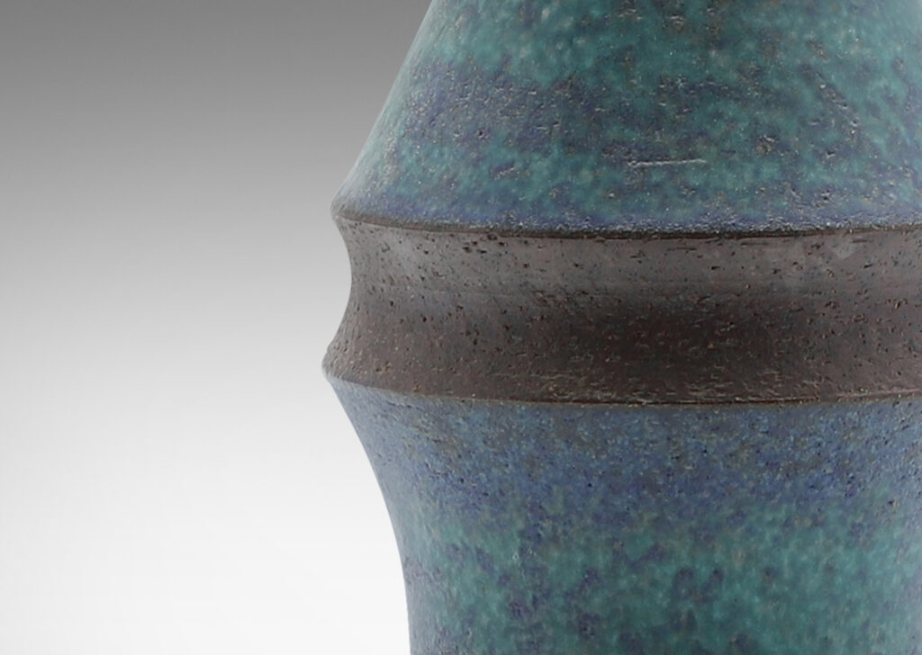 Gallery BAC notched pawn-like form with conical cap, glazed in mottled turquoise and azure tones with brown