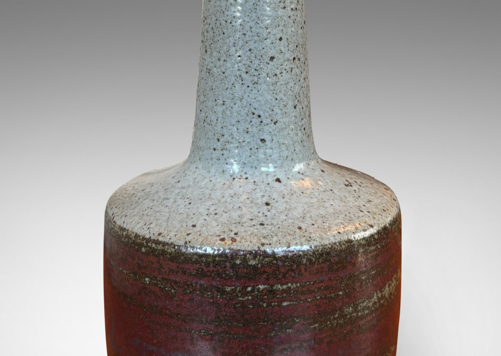 Gallery BAC drum form with tall conical neck, glazed in a speckled gray and gunmetal gray-red luster