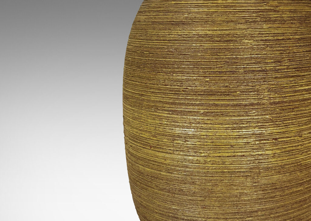 Gallery BAC ovoid forms with horizontally raked texture and matte ochre-tan glaze