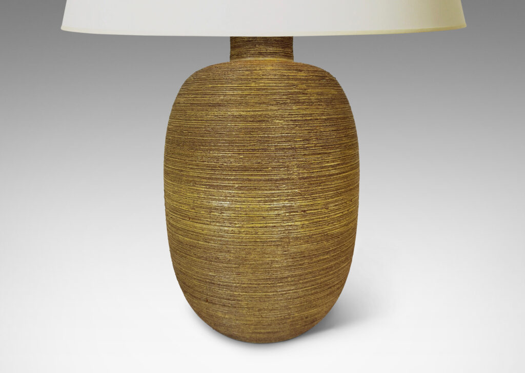 Gallery BAC ovoid forms with horizontally raked texture and matte ochre-tan glaze