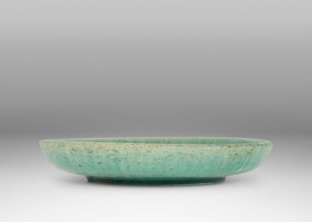 Gallery BAC flat bottom with carved swirling motifs and angled sides, with a thin turquoise glaze