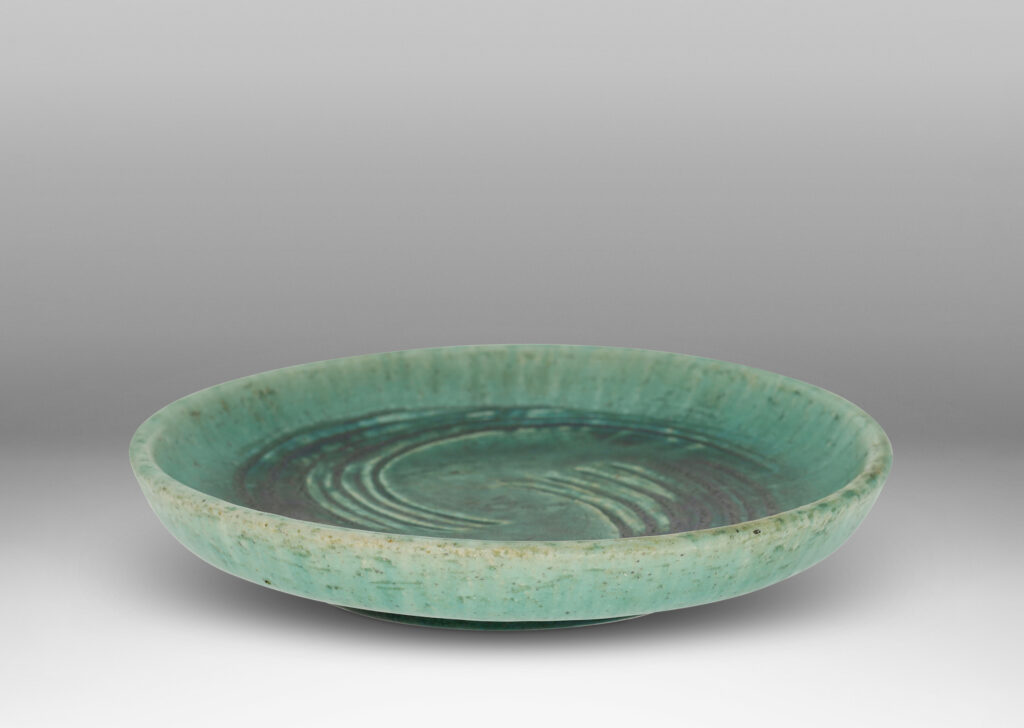 Gallery BAC flat bottom with carved swirling motifs and angled sides, with a thin turquoise glaze