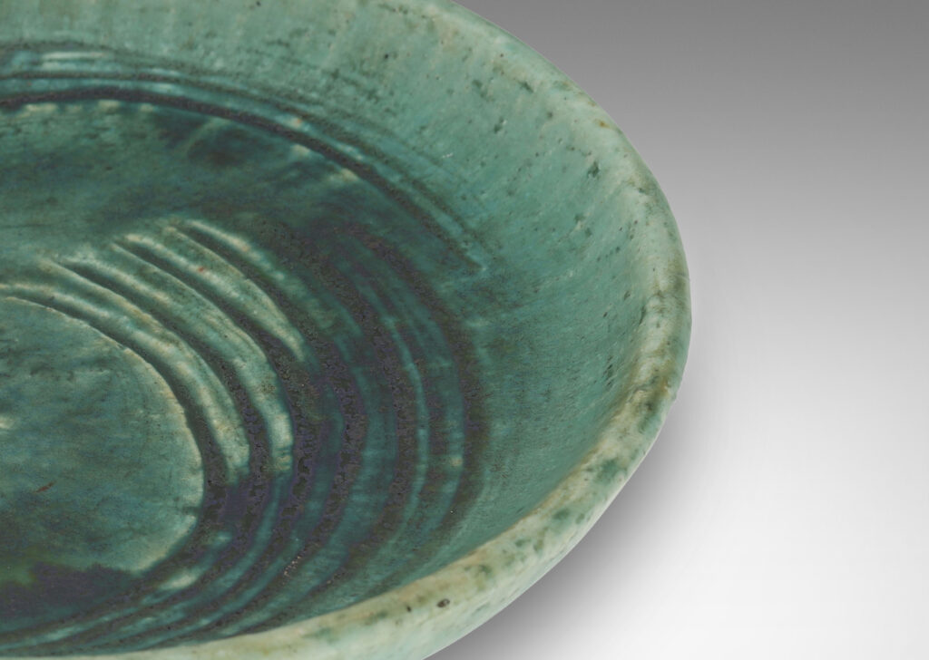 Gallery BAC flat bottom with carved swirling motifs and angled sides, with a thin turquoise glaze