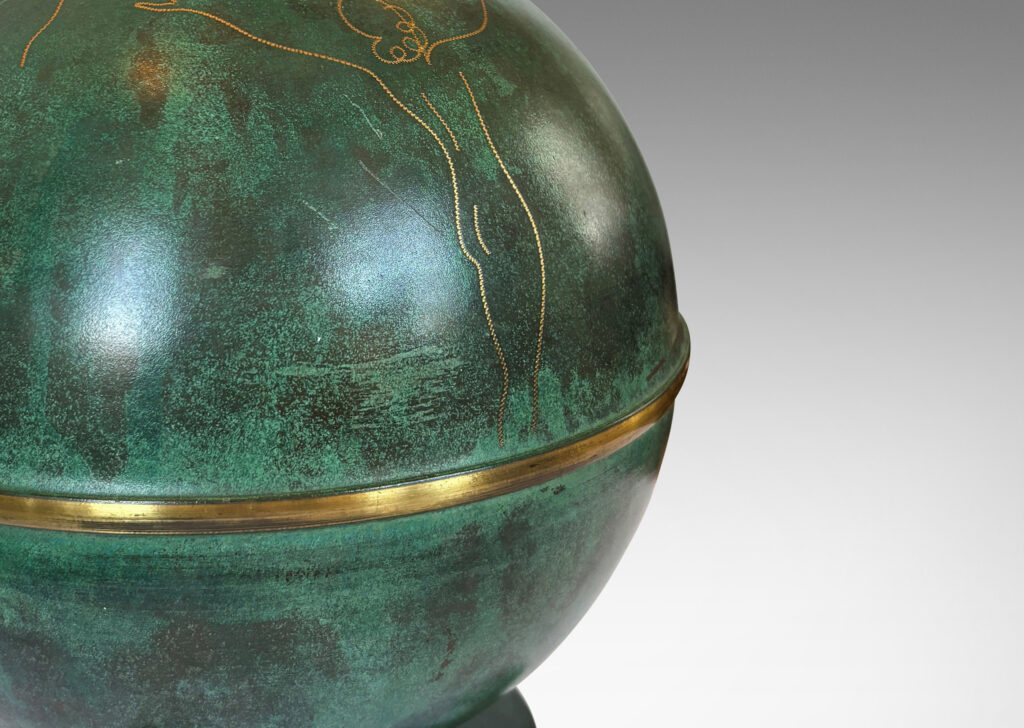 Gallery BAC globe form mounted on a stand with sculpted legs and featuring an immaculate original verdigris finish and subtle engraved designs; bronze with iron weight