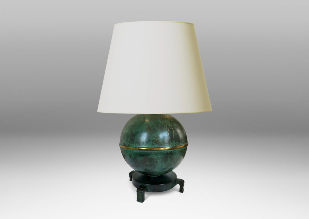 Gallery BAC globe form mounted on a stand with sculpted legs and featuring an immaculate original verdigris finish and subtle engraved designs; bronze with iron weight