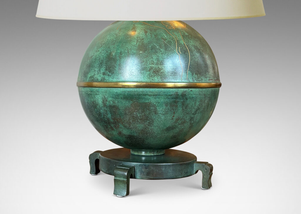 Gallery BAC globe form mounted on a stand with sculpted legs and featuring an immaculate original verdigris finish and subtle engraved designs; bronze with iron weight