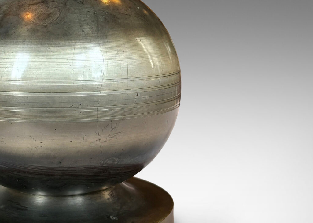 Gallery BAC plump spherical form with engraved lines on a disk base; steel and brass