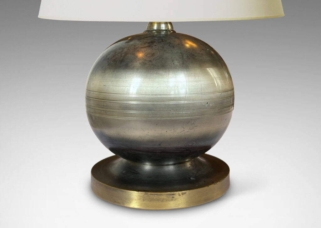 Gallery BAC plump spherical form with engraved lines on a disk base; steel and brass