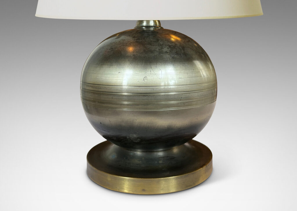 Gallery BAC plump spherical form with engraved lines on a disk base; steel and brass