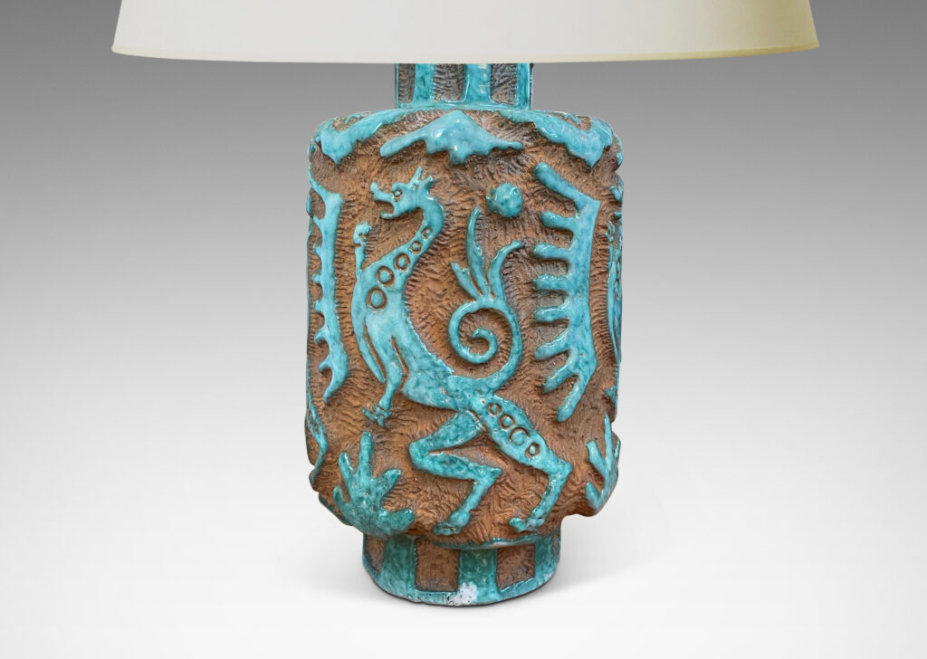 Gallery BAC cylindrical "albarello" form encircled with carved dragons and exotic motifs, partially glazed in a pale jade green, with matte terra cotta background