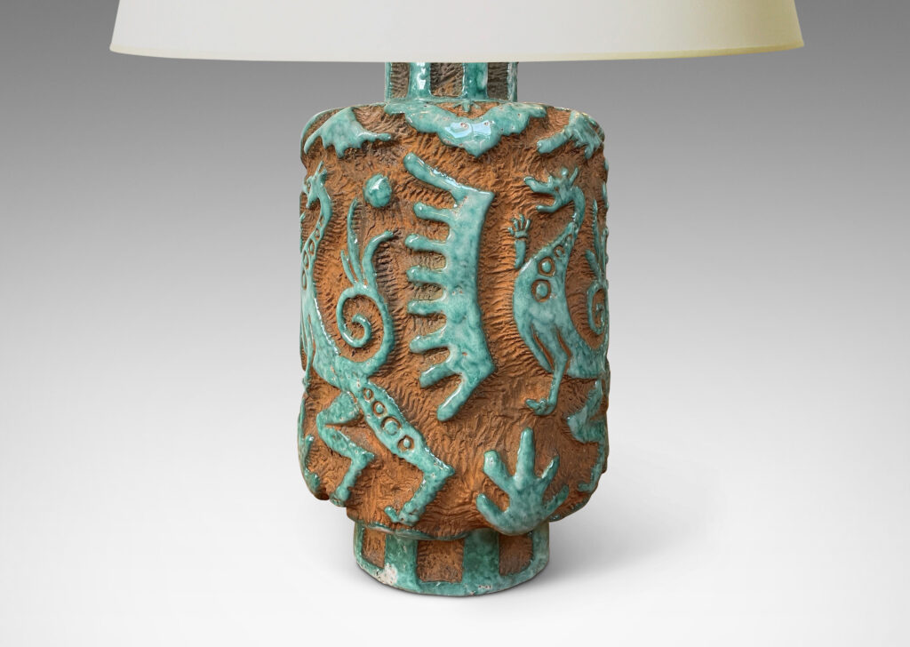 Gallery BAC cylindrical "albarello" form encircled with carved dragons and exotic motifs, partially glazed in a pale jade green, with matte terra cotta background