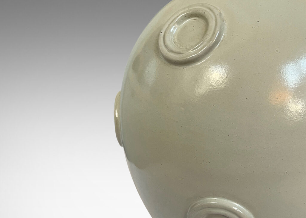 Gallery BAC ovoid form with applied relief floating circle motifs, glazed in a pale greige tone