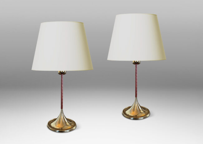 Gallery BAC slender stands wrapped in whiskey-tinted leather, with wide flaring bases