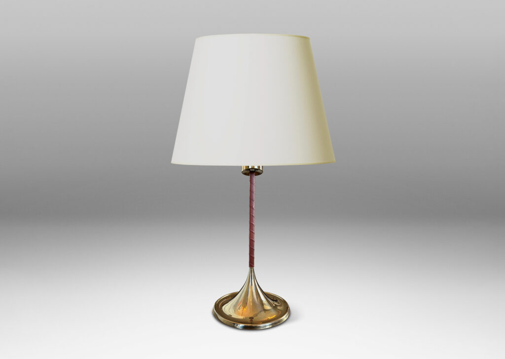 Gallery BAC slender stands wrapped in whiskey-tinted leather, with wide flaring bases