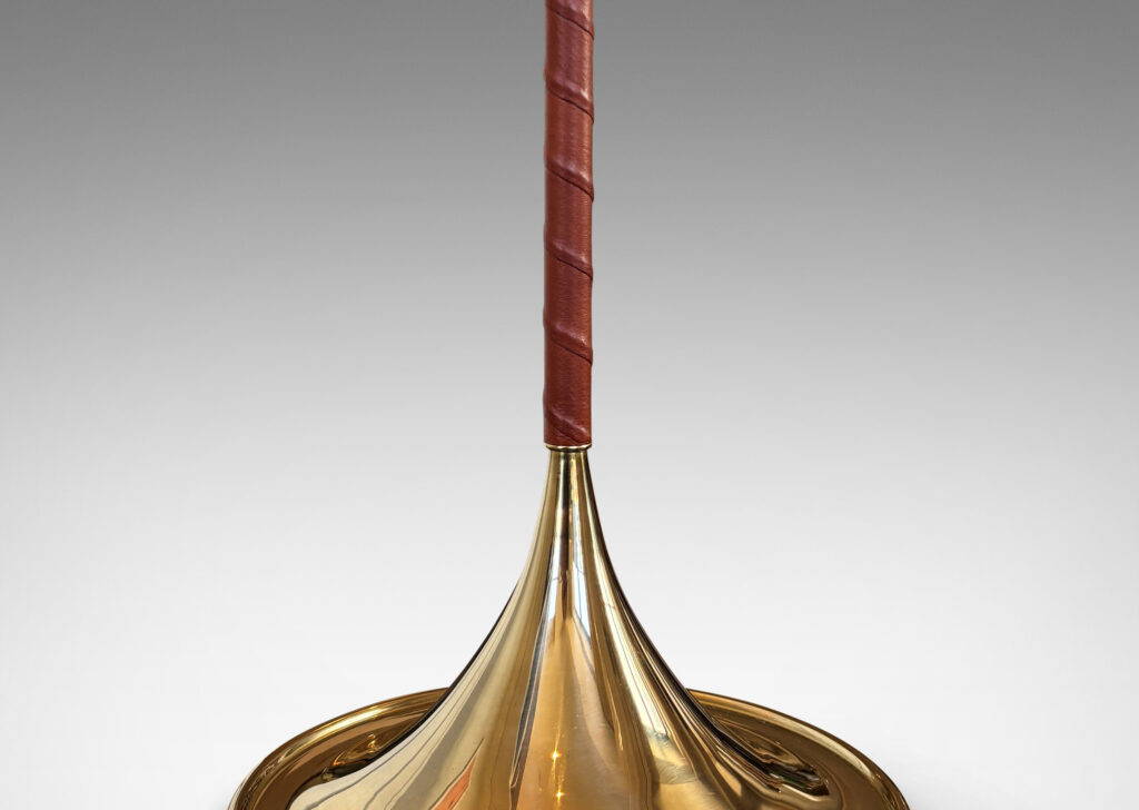 Gallery BAC slender stands wrapped in whiskey-tinted leather, with wide flaring bases