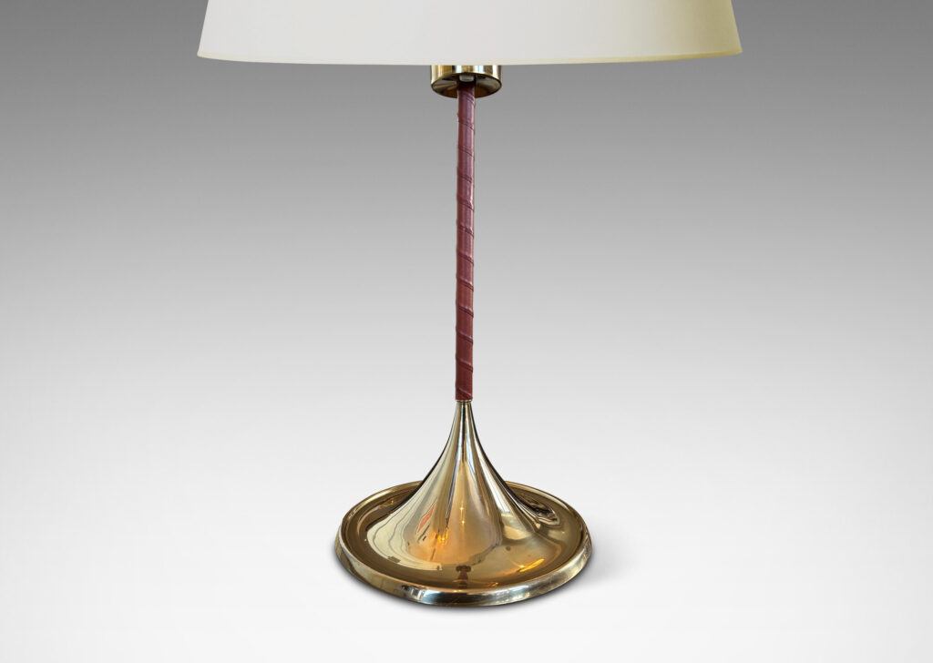 Gallery BAC slender stands wrapped in whiskey-tinted leather, with wide flaring bases