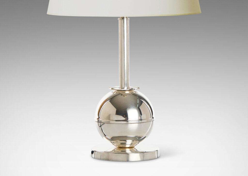 Gallery BAC globe form on a disk plinth, joined to a tall stand with a star-like rosette fob, silver plate