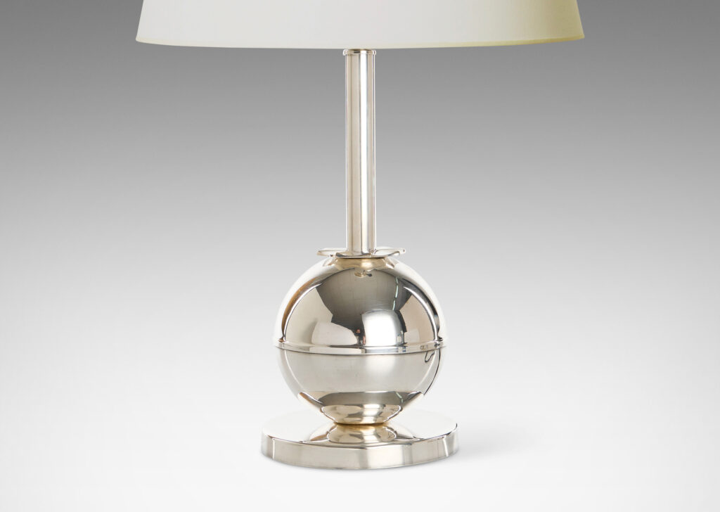 Gallery BAC globe form on a disk plinth, joined to a tall stand with a star-like rosette fob, silver plate