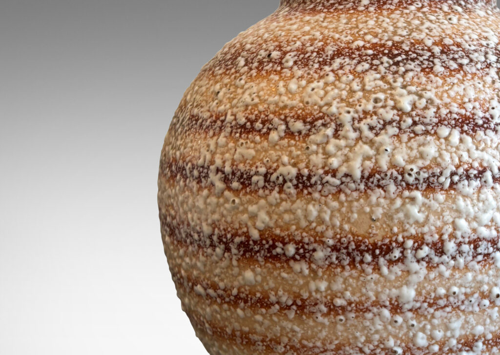 Gallery BAC globe form with calabash-like neck, in ombre tan and brown horizontal banding, with white “crispé” style overglaze