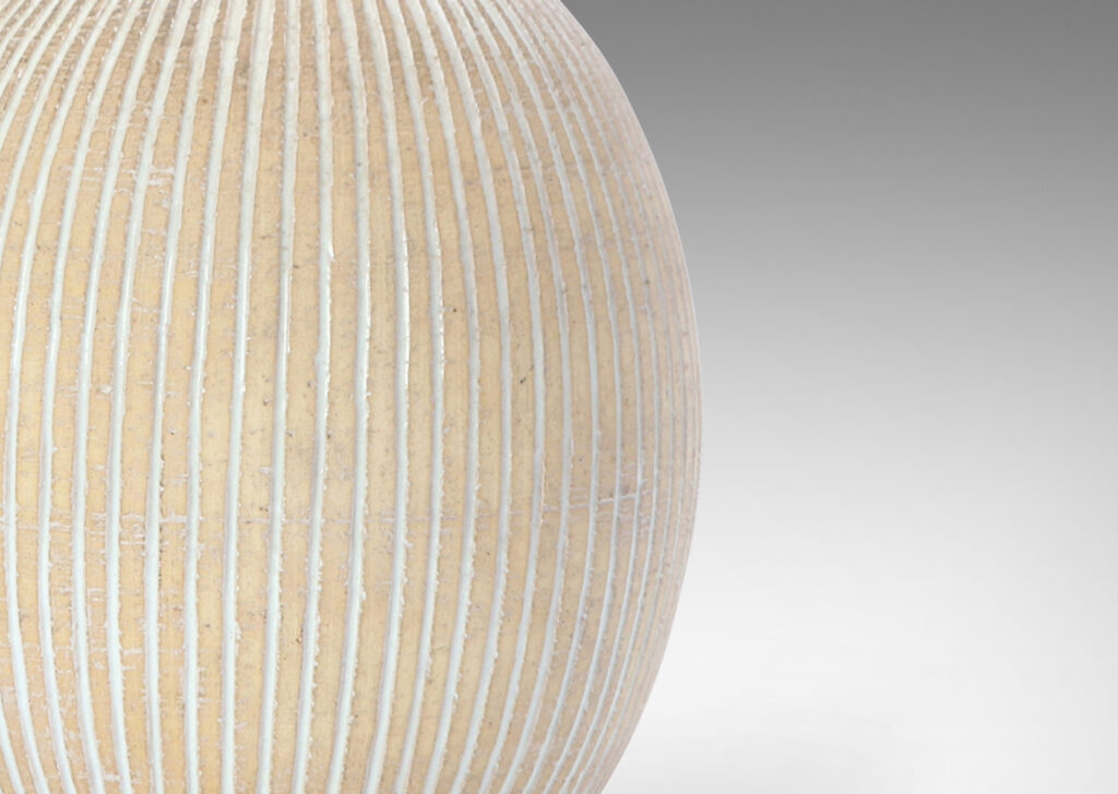 Gallery BAC light tan ovoid form with carved and white-glazed vertical pinstripes