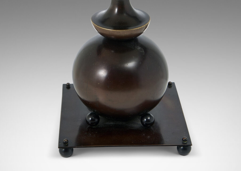 Gallery BAC globe form with tiered coved stand and square base supported on ball feet, all with a wonderful original patination