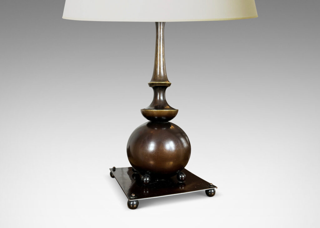 Gallery BAC globe form with tiered coved stand and square base supported on ball feet, all with a wonderful original patination