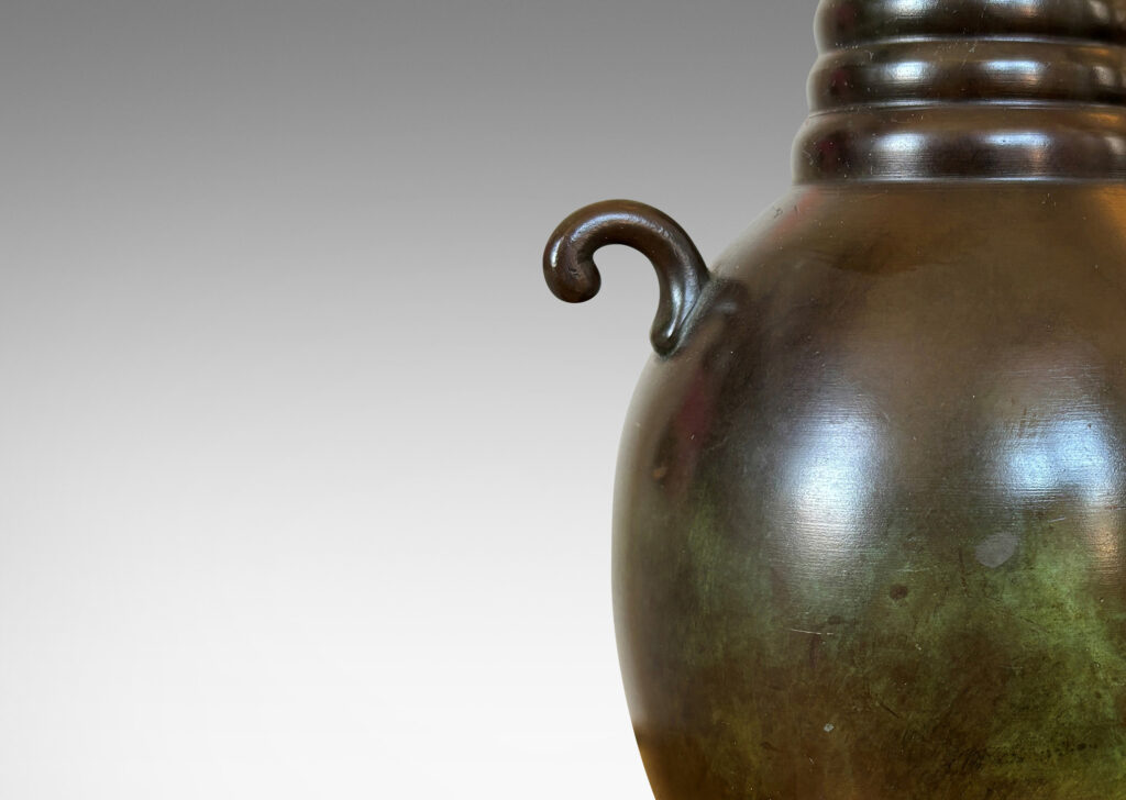 Gallery BAC upright ovoid form with flared base, ringed neck, and scroll handles, patinated in a handsome antique tone with verdigris highlights; bronze