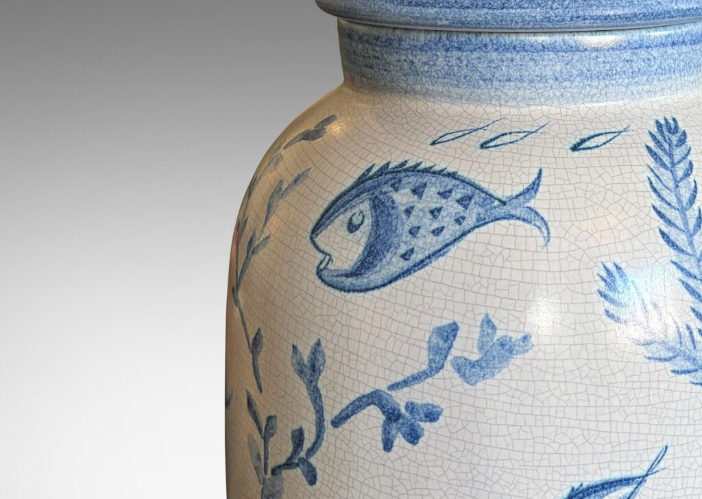 Gallery BAC tall ovoid form with fish form finial, glazed in a craquel white, surrounded with charming hand-painted pictures of marine flora and fauna in blue