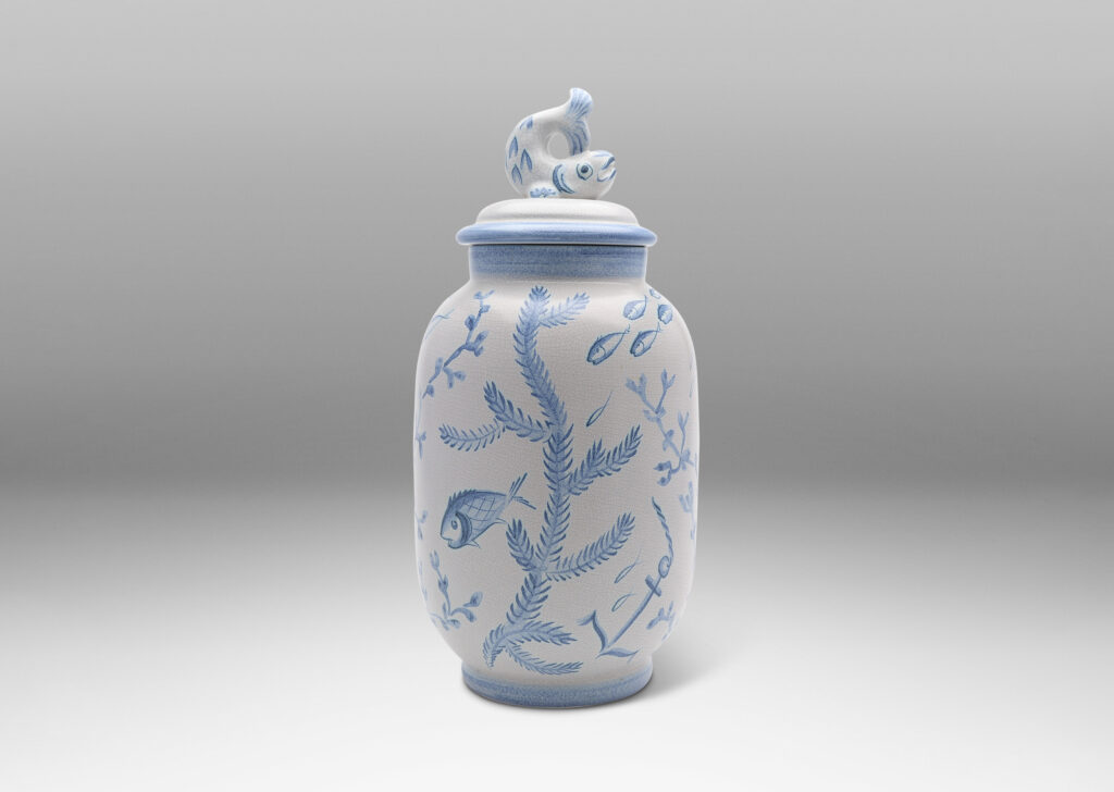 Gallery BAC tall ovoid form with fish form finial, glazed in a craquel white, surrounded with charming hand-painted pictures of marine flora and fauna in blue